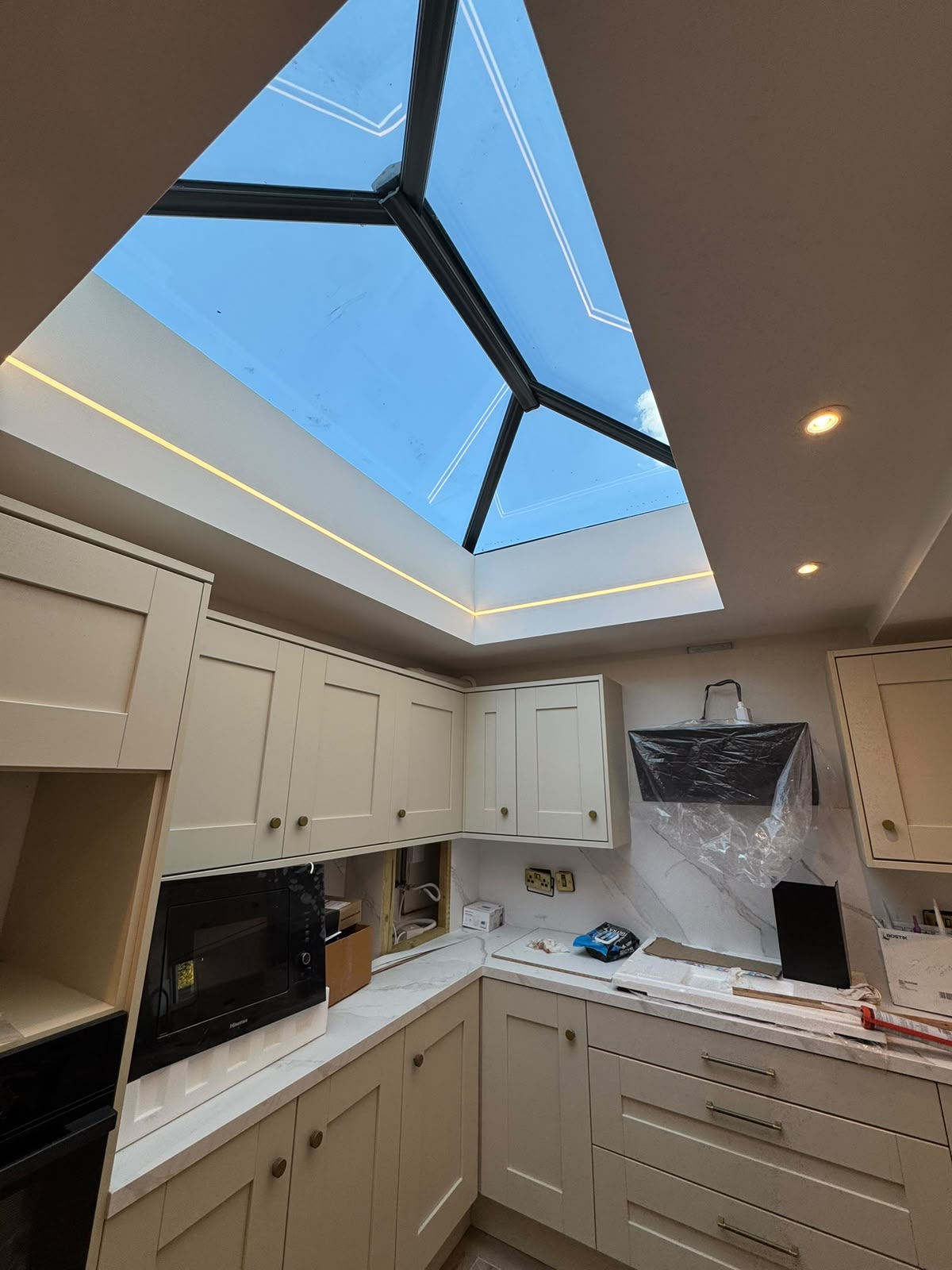 Kitchen with lantern rooflight and recessed downlights